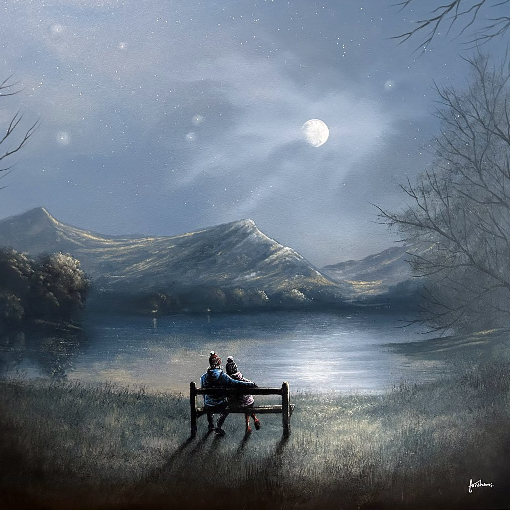 a couple looking over the Lake District fells in the moonlight at Derwent Water Keswick