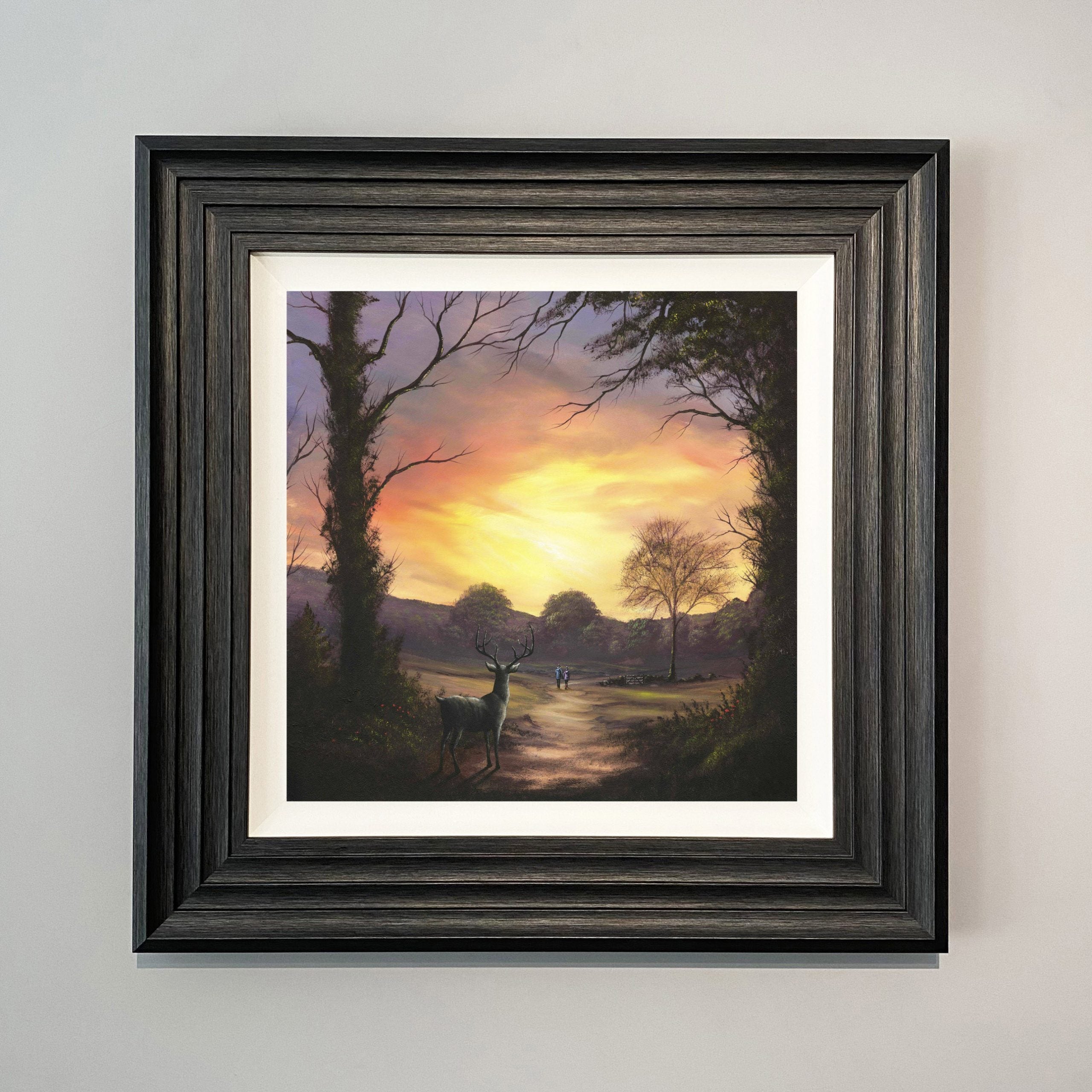 A touch of curiosity landscape artwork by Danny Abrahams featuring a stag standing on a woodland path with couple walking